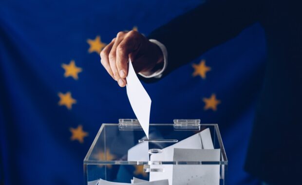 Man throwing his vote into the ballot box.