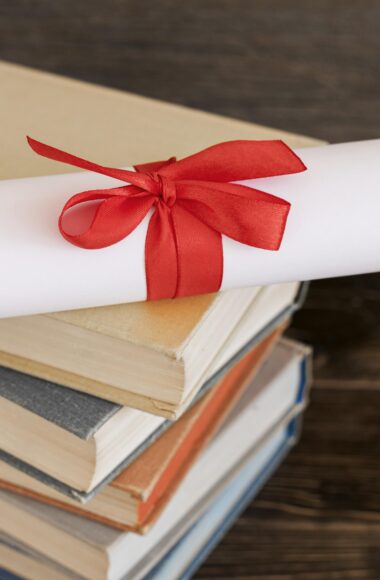 Immagine di alcuni libri e una pergamena di laurea