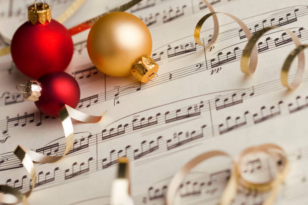 A classical music score with baubles and ribbons.