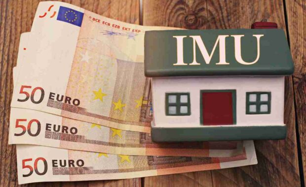 house with euro banknotes with the sign "Imu" italian tax