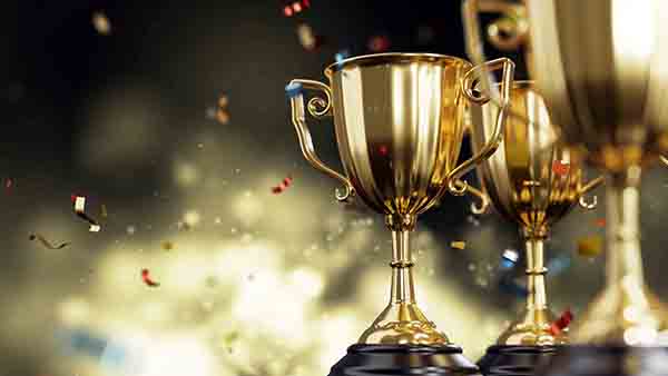 Golden trophy cup on dark background. copy space for text. 3d rendering.